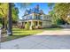 Large two-story house with a wrap-around porch and brick accents at 26 Oak St, Roxboro, NC 27573