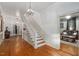 Bright entryway with hardwood floors, staircase, and chandelier at 26 Oak St, Roxboro, NC 27573