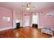 Charming bedroom with hardwood floors, fireplace, and decorative accents at 26 Oak St, Roxboro, NC 27573