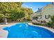 Inviting kidney shaped pool with backyard and home visible at 26 Oak St, Roxboro, NC 27573