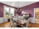 Elegant dining room with chandelier and hardwood floors, kitchen view at 26 Oak St, Roxboro, NC 27573