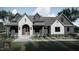Modern farmhouse exterior with stone accents at Lot 5 Joyful Creek Trl, Zebulon, NC 27597