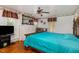 Spacious Primary bedroom with teal bedding and hardwood floors at 415 N Hyde Park Ave, Durham, NC 27703