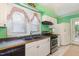 Galley kitchen with white cabinets and double sink at 415 N Hyde Park Ave, Durham, NC 27703
