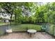 Wooden deck with backyard view, green chairs, and small table at 415 N Hyde Park Ave, Durham, NC 27703