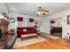 Bright living room with hardwood floors, fireplace and red sofa at 415 N Hyde Park Ave, Durham, NC 27703