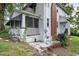 White house with brick chimney and screened porch at 415 N Hyde Park Ave, Durham, NC 27703