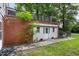 House exterior with brick wall and white shed at 415 N Hyde Park Ave, Durham, NC 27703