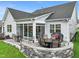 Stone patio with seating area and grill adjacent to house at 179 Ivory Ln, Raleigh, NC 27610