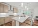 Island kitchen with white quartz countertops and stainless steel appliances at 179 Ivory Ln, Raleigh, NC 27610