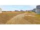 Spacious backyard with dry grass and a playset in the distance at 420 Oak Park Blvd, Youngsville, NC 27596