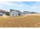 View of the backyard and back of the house with a wooden fence at 420 Oak Park Blvd, Youngsville, NC 27596