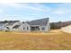 View of the backyard and back of the house with surrounding homes at 420 Oak Park Blvd, Youngsville, NC 27596