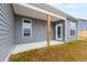 Backyard with covered patio, gray siding, and some dead grass at 420 Oak Park Blvd, Youngsville, NC 27596