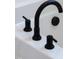 Close-up of oil-rubbed bronze bathtub faucet at 420 Oak Park Blvd, Youngsville, NC 27596