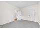 Spare bedroom with gray carpet, white walls, and open door at 420 Oak Park Blvd, Youngsville, NC 27596