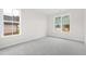 Empty bedroom with gray carpet and multiple windows at 420 Oak Park Blvd, Youngsville, NC 27596