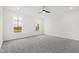 Spacious bedroom with gray carpet, ceiling fan, and large windows at 420 Oak Park Blvd, Youngsville, NC 27596