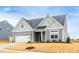 Charming two-story home with a gray exterior, white trim, and attached two-car garage at 420 Oak Park Blvd, Youngsville, NC 27596