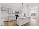 Kitchen island with white quartz countertop, gray shaker cabinets, and stainless steel appliances at 420 Oak Park Blvd, Youngsville, NC 27596