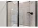 Modern walk-in shower with gray tile and black frame glass door at 420 Oak Park Blvd, Youngsville, NC 27596