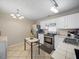 Kitchen features stainless steel appliances and white cabinets at 7017 Jeffreys Creek Ln, Raleigh, NC 27616