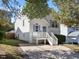 Two-story house with white siding, a porch, and a driveway at 7017 Jeffreys Creek Ln, Raleigh, NC 27616