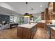 Open concept kitchen with island, stainless steel appliances, and hardwood floors at 3723 Bellevue Rd, Raleigh, NC 27609