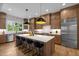 Modern kitchen with an island, stainless steel appliances, and hardwood floors at 3723 Bellevue Rd, Raleigh, NC 27609