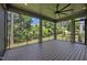 Relaxing screened porch with hardwood flooring and ceiling fan at 3723 Bellevue Rd, Raleigh, NC 27609
