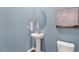 Small powder room with pedestal sink and oval mirror at 203 Calebs Corner Pl, Spring Lake, NC 28390