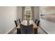 Elegant dining room with wood table and gray chairs at 203 Calebs Corner Pl, Spring Lake, NC 28390