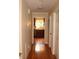 Long hallway with hardwood floors leading to kitchen at 568 Log Barn Rd, Pittsboro, NC 27312