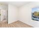 Bedroom with large window, wood-look floors and access to a bathroom at 112 N Guthrie Ave # A, Durham, NC 27703
