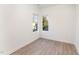 Small bedroom with two windows and wood-look floors at 112 N Guthrie Ave # A, Durham, NC 27703