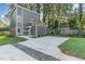 Two-story home with gray siding, a deck, and a concrete driveway at 112 N Guthrie Ave # A, Durham, NC 27703