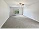 Spacious bedroom with neutral carpeting and large window at 2504 Timothy Dr, Fuquay Varina, NC 27526