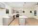 Modern kitchen with island, stainless steel appliances, and light grey cabinets at 112 N Guthrie Ave # B, Durham, NC 27703