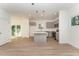 Modern kitchen with island, stainless steel appliances, and light grey cabinets at 112 N Guthrie Ave # B, Durham, NC 27703