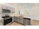 Modern kitchen with gray cabinets and stainless steel appliances at 112 N Guthrie Ave, Durham, NC 27703