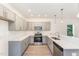 Modern kitchen with gray cabinets and stainless steel appliances at 112 N Guthrie Ave, Durham, NC 27703