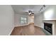 Living room with fireplace, wood-look floors, and ceiling fan at 1414 Arborgate Cir, Chapel Hill, NC 27514