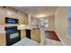 Kitchen with wood cabinets, black appliances, and a breakfast bar at 1414 Arborgate Cir, Chapel Hill, NC 27514