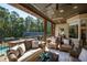 Relaxing covered patio with wicker furniture and a view of the pool at 2117 Blue Haven Ct, Wake Forest, NC 27587