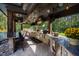 Full outdoor kitchen, granite counters, stainless steel appliances at 2117 Blue Haven Ct, Wake Forest, NC 27587