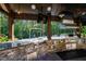 Stainless steel appliances and stonework in this outdoor kitchen at 2117 Blue Haven Ct, Wake Forest, NC 27587