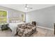 Bedroom with a queen-size bed, two armchairs and a ceiling fan at 2117 Blue Haven Ct, Wake Forest, NC 27587