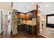 Basement wet bar with stone accents and mini-fridge at 2117 Blue Haven Ct, Wake Forest, NC 27587