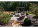Relaxing fire pit area with wicker seating and pergola at 2117 Blue Haven Ct, Wake Forest, NC 27587