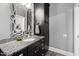 Bathroom with dark vanity, granite countertop and large mirror at 2117 Blue Haven Ct, Wake Forest, NC 27587